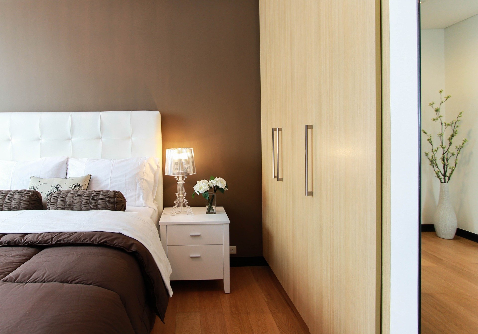 a closet in a bedroom next to a bed