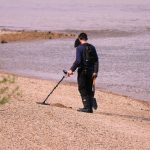 man using a metal detector