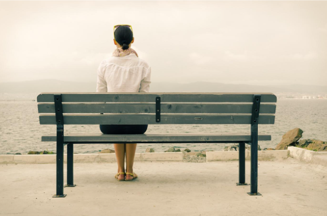 Solitary figure facing the ocean, echoing the emotional weight and historical silence surrounding the comfort women narrative.